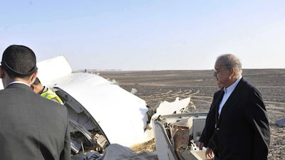 Egyptian Prime Minister Sherif Ismail, right, looks at the remains of the crashed passenger jet in Hassana, Egypt on Saturday. The prime minister said experts had confirmed that the militants could not down a plane at the 9,000 metre altitude the Airbus A321 was flying. Suliman el-Oteify / Egyptian Prime Minister’s Office via AP