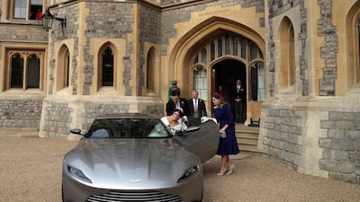 Britain's Princess Eugenie and her new husband Jack Brooksbank depart their wedding in an Aston Martin DB10. AFP