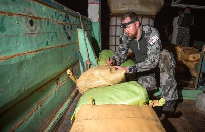 Petty Officer Leslie Floyd numbers parcels of seized drugs as HMAS Warramunga’s boarding team conduct an illicit cargo seizure in 2018. Courtesy: Royal Australian Navy