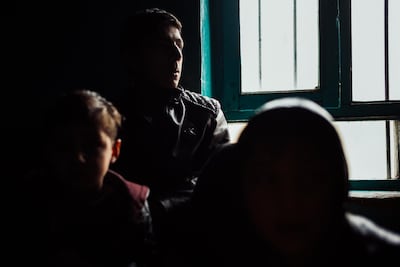 Some of Alia's siblings sit near the window of their home that was damaged by a bomb attack against the Green Village in Kabul, Afghanistan on January 14 2019. Ivan Flores/The National