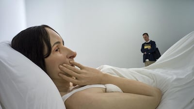 A visitor looks at the sculpture ‘In bed’ by Australian artist Ron Mueck on display during the exhibition ‘Vivid Memories’ at the Fondation Cartier Museum in Paris, France. Yoan Valat / EPA