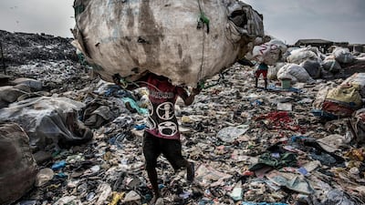 Kadir van Lohuizen took first place in the 'Environment - Stories' category with this image from a story that shows a man as he carries a huge back of pet bottles collected for recycling at the Olusosun landfill in Lagos, Nigeria. EPA/KADIR VAN LOHUIZEN/NOOR IMAGES