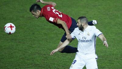 Real Madrid’s Karim Benzema in action against Kashima Antlers’ Naomichi Ueda. Issei Kato / Reuters
