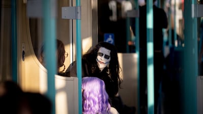 A cosplayer dressed as Joker travels on a DLR train after attending London's MCM Comic Con. EPA