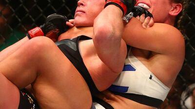 Miesha Tate applies a chokehold to win by submission against Holly Holm during UFC 196 at MGM Grand Garden Arena. USA Today