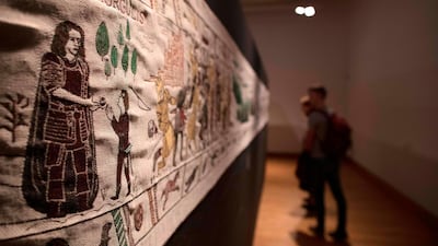 Members of the public look at completed sections of a tapestry depicting the hit television series Game of Thrones at the Ulster Museum in Belfast. Like the Bayeux Tapestry, the Game of Thrones Tapestry is woven of fine linen and hand-embroidered, with decorative borders and a central pictorial narrative. It will reach 90m by the end of the final season of the show. AFP