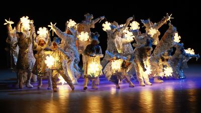 Dancers hold lanterns during the closing ceremony at the National Stadium. EPA