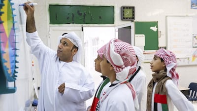 Teacher Khalifa Al Naimi instructs pupils in maths at Al Tamayoz Model School in Al Ain. Delores Johnson / The National