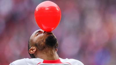 RB Leipzig's Christopher Nkunku inflates a balloon as he celebrates scoring against Hoffenheim in a Bundesliga match in Leipzig, Germany. AP