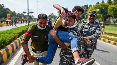 Police detain a man who was protesting near the Chinese embassy to mark the 63rd Tibetan uprising anniversary in New Delhi. AFP