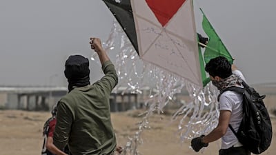 Palestinian protesters fly a kite during clashes near the Israel border in the east of Gaza City, on April 20, 2018. Mohammed Saber / EPA