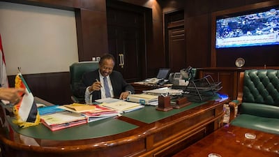 Abdalla Hamdok signing documents a few hours after assassination attempt