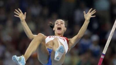 Russia's Yelena Isinbayeva clears the bar to break the world record as she wins gold in the women's pole vault final.