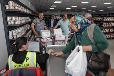 People get food aid at the market of AFAD, the Turkish Disaster and Emergency Management Presidency in Nurdagi district of Gaziantep. EPA