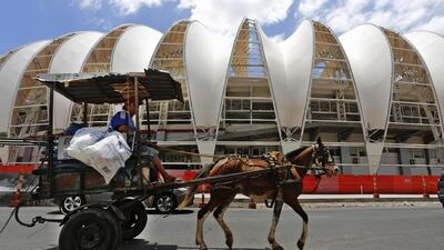 This December 12, 2013 file photo shows a horse carriage passing the Estadio Beira-Rio in Porto Alegre, Brazil. Ferdinand Ostrop / AP