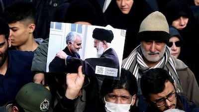A demonstrator holds a picture of Ayatollah Ali Khamenei with Iranian Major-General Qassem Suleimani, during protest against the assassination of Suleimani and Iraqi militia commander Abu Mahdi Al Muhandis in Tehran, Iran. Reuters