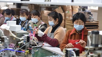Employees working on an assembly line producing speakers at a factory in Linquan county, Fuyang city, in China's eastern Anhui province. China's retail sales slumped to its lowest in over two years while factory output plunged, official data showed on May 16, 2022, capturing the fallout from Beijing's zero-Covid policy. AFP