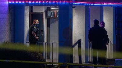 Police officers are seen outside a massage parlor where three people were shot and killed in Atlanta, Georgia. Eight people were killed in shootings at three different spas in the US state of Georgia on March 16, police and local media reported. It is "extremely likely" that the same suspect was involved in all three deadly shootings at spas in the US state of Georgia, police told AFP Tuesday. The suspect, named as 21-year-old Robert Aaron Long, is in police custody in the violence that reportedly killed eight people. AFP