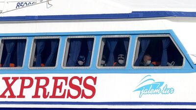 Frontex officers are seen behind the windows of a Greek ferry carrying refugees back to Turkey from the Greek island of Lesbos as it arrives at Dikili Harbour in Izmir, Turkey. Some 160 migrants, from Pakistan, Bangladesh and Morroco, who refused to apply for asylum, were deported under an agreement between the EU and Turkey on the refugee crisis. Tolga Bozoglu / EPA