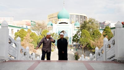 Two Hui Muslim men ascend the staircase towards the mosque. Sarah Dea / The National