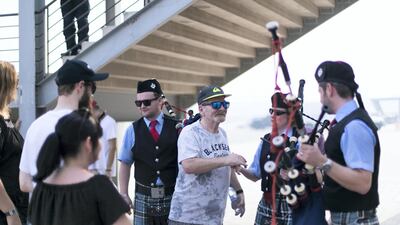 Gilchrist’s father thanks the bagpipers at his son’s memorial. Reem Mohammed / The National