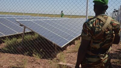 A member of the military is stationed in front of solar panels at the Irhazer borehole project in Niger, which is financed by France. AFP