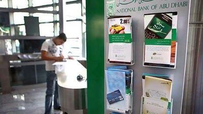 UAE banks including National Bank of Abu Dhabi are gearing up to comply with Central Bank caps on their loan exposure to the Government and to companies linked to it. Delores Johnson / The National