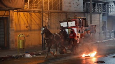 Palestinians bring materials on a horse drawn cart to build a burning barricade as they clash with Israeli security forces during a protest against US President Donald J. Trump's Middle East peace plan to solve the conflict between Palestinians and Israel, near the West Bank City of Hebron. EPA