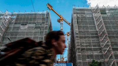 A cyclist passes a building construction site in Berlin's Mitte district on May 28. A freeze on residential rents was imposed in Berlin five years ago following a wave of property speculation that led to rents doubling. AFP