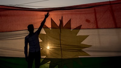 A man in front of a Kurdish flag during a protest outside the US Consulate in Erbil, Iraq, in 2017. Getty Images