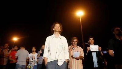 Erdem Gunduz ((centre) staged an eight-hour silent vigil in Istanbul's Taksim Square on Monday. Hundreds have followed.