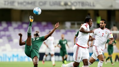 UAE striker Ahmed Khalil, centre, and Saudi Arabia's Omar Ibrahim Othman in action during their World Cup qualifier at Hazza bin Zayed Stadium on Tuesday. Chris Whiteoak / The National