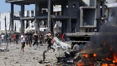 Palestinians gather at the site of an Israeli strike in Maghazi. AFP