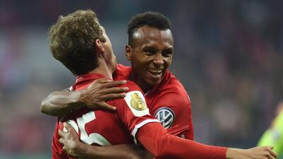 Bayern Munich’s US midfielder Julian Green celebrates with Thomas Muller after scoring the second goal. Christof Stache / AFP / October 26, 2017