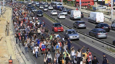 Migrants walk towards the border with Austria from the Hungarian capital Budapest on September 4, 2015. Bernadett Szabo / Reuters