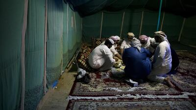 Emirati men eat food together during the Liwa International Festival near. Christopher Pike / The National