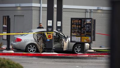 Police investigate a crime scene where Jontae Adams, 28, and his daughter Jaslyn, 7, were shot, resulting in Jaslyn's death at a McDonald's drive-thru, in Chicago. AP