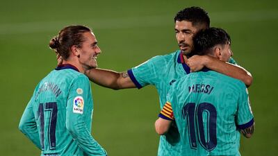 Antoine Griezmann celebrates with Lionel Messi and Luis Suarez. AFP