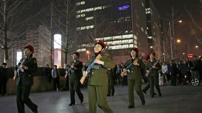 Chinese women holding toy guns march to a revolutionary song during their daily exercises at a square outside a shopping mall in Beijing on March 24, 2015. Andy Wong/AP Photo