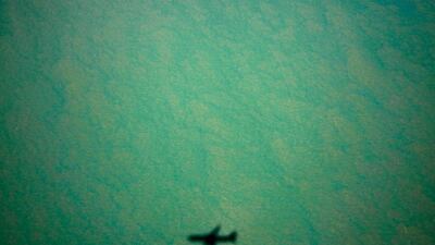 A Boeing 767 plane casts a shadow above a bay near Arnhem Land.