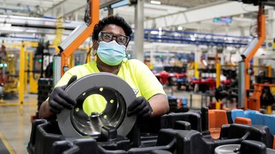 A Dana Inc. assembly technician wears a face mask as she assembles axles for automakers, as the auto industry begins reopening amid the coronavirus disease (COVID-19) outbreak, at the Dana plant in Toledo, Ohio,U.S. REUTERS
