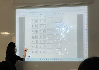 Learning to write the Korean alphabet, Hangul, at the Korean Cultural Centre in Abu Dhabi. Evelyn Lau / The National