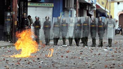 Security forces look on while clashing with opposition supporters in Tachira, Venezuela. Reuters