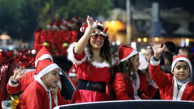 Syrians dressed in Santa Claus costumes take part in street celebrations held in the mostly Christian-populated Bab Touma neighborhood in the Olld City of Damascus, Syria. EPA