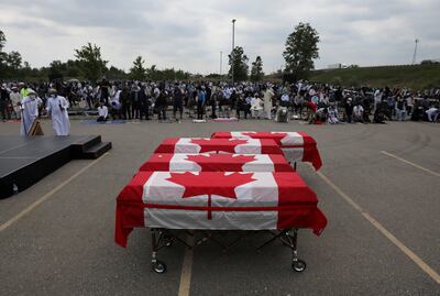 Flag-wrapped coffins are seen outside the Islamic Centre of Southwest Ontario during the funeral for the Afzaal family in June 2021. Reuters