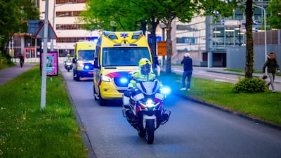 A convoy of ambulances believed to be carrying at least one person from the cruise ship is escorted by Dutch police in Leiden. AFP