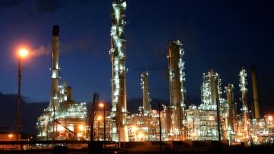 FILE PHOTO: Thailand's largest oil refinery, Thai Oil, lights up in the evening in Sri Racha August 17, 2004. REUTERS/Sukree Sukplang/File Photo