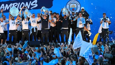 Manchester City players and staff on stage during the trophy parade in Manchester, England, after winning the English FA Cup. Victory for Pep Guardiola’s side came a week after the English Premier League trophy was retained to join the League Cup and Community Shield already in City’s possession. AP