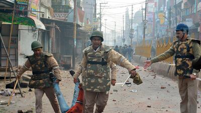 Security personnel detain a protester during demonstrations against India's new citizenship law in Meerut. AFP