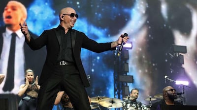 Mirroring the lyrics or his songs, Pitbull surrounds himself with images of sharp suits, glamorous females, fast cars and gleaming cityscapes on stage at the Du Arena on November 24, 2016, at the first 2016 Abu Dhabi Grand Prix after-race concert.